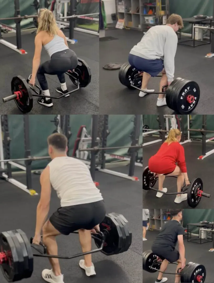 People deadlifting in a gym setting.