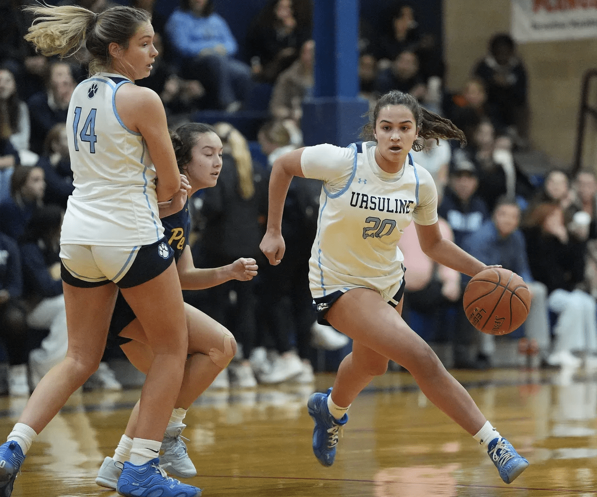 Ursuline player dribbling past defender