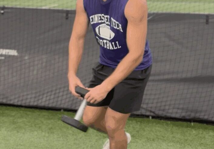 Man balancing on pad during workout.