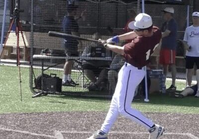 Baseball player swinging bat at a pitch.