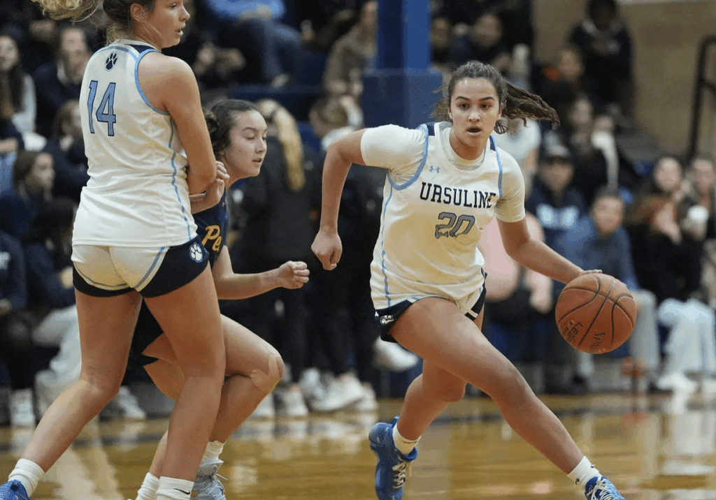 Ursuline player dribbling past defender