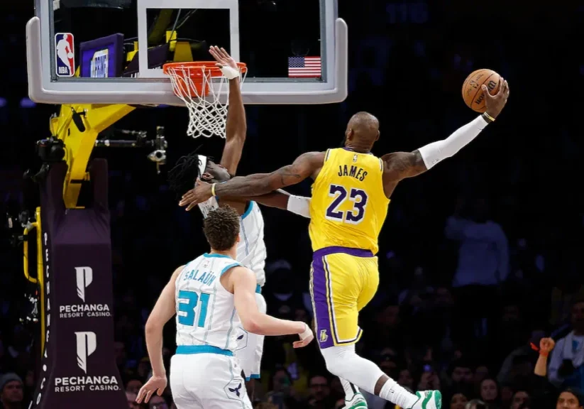 Basketball player in yellow jersey driving to hoop