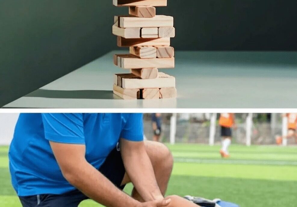 Stacked wooden blocks and athlete receiving leg treatment.